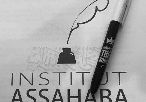 Livre ouvert avec un stylo posé dessus symbolisant l’apprentissage de l’arabe à l’institut As-Sahaba